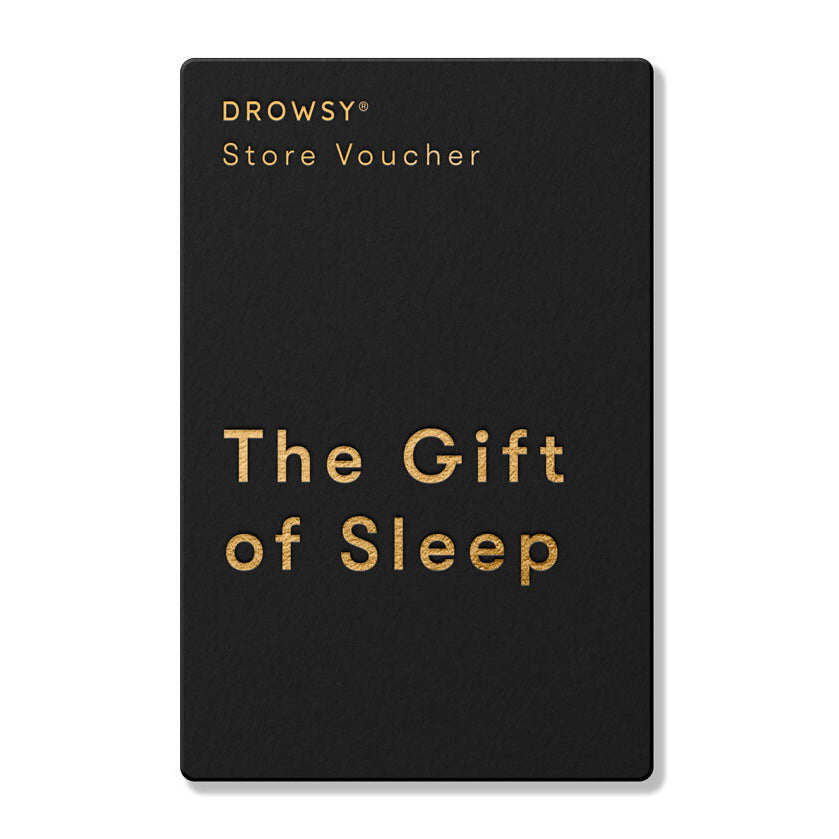 A sleek black Drowsy Sleep Co. Gift Card from us.drowsysleepco features gold text and “The Gift of Sleep” in the center, making it the perfect sleep-themed present.