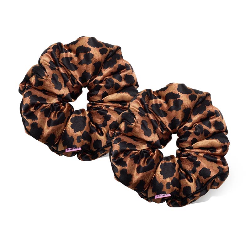 Two Hotel Paradiso - Wild Thing Padded Scrunchies by us.drowsysleepco, featuring a brown and black leopard print with pink tags, are shown side by side. These oversized silk scrunchies boost hair volume and add a stylish flair.
