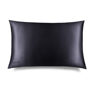 The Moonlight Shadow Silk Pillowcase by us.drowsysleepco features a smooth black rectangular design with a subtle sheen, ideal for skin and hair care, and has "DROUZZE" discreetly printed on the bottom left against a white background.