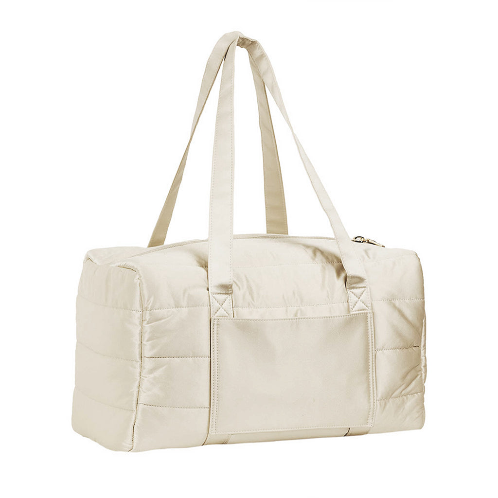 The Drowsy Silk Weekender in Dusty Gold by Drowsy features a beige quilted design, double handles, an exterior pocket, and a top zipper closure, shown against a white background.