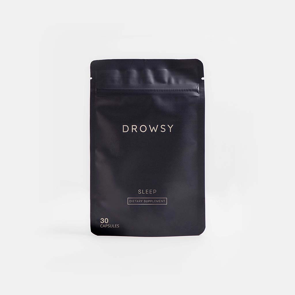 A black resealable pouch labeled drowsysleepco’s Sleep Supplement Subscription contains 30 capsules for sleep. The minimalist packaging is shown against a plain, light background.