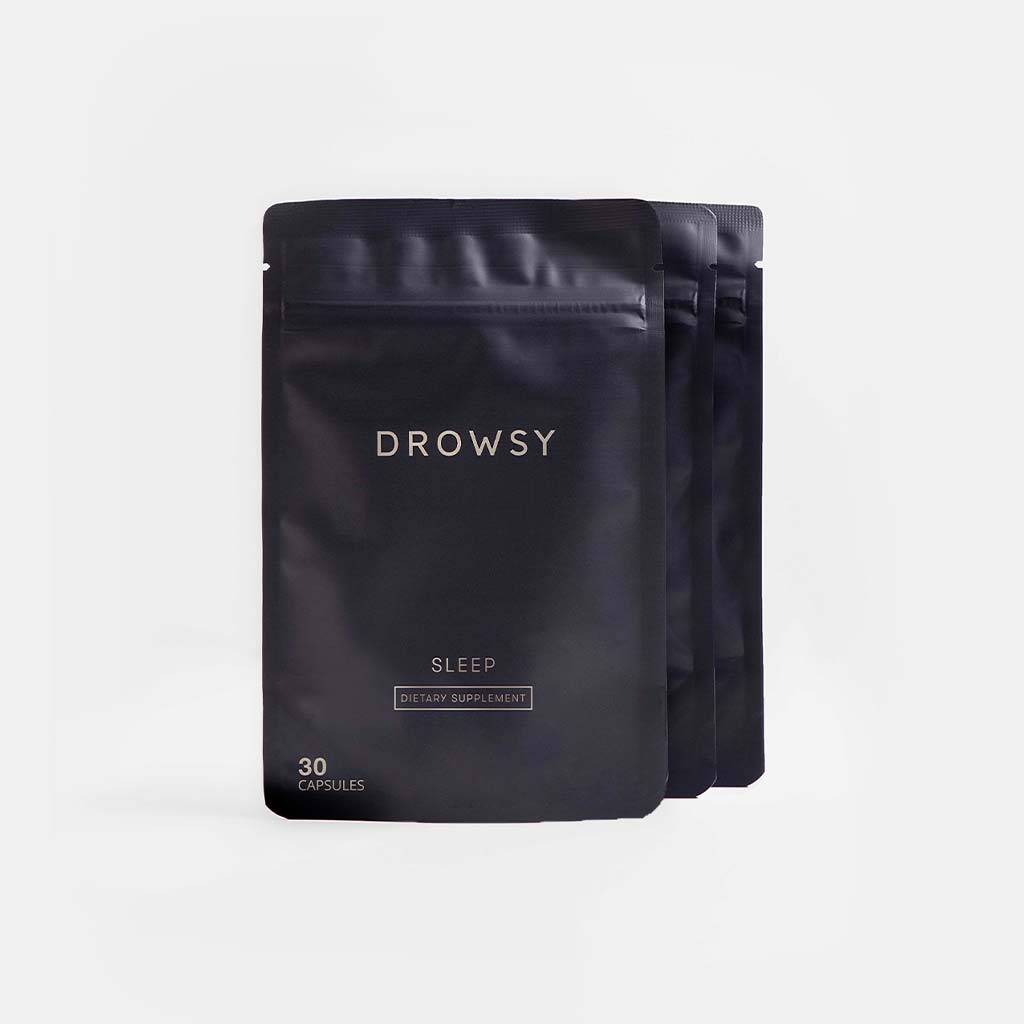 Three black resealable pouches of drowsysleepcos Sleep Supplement Subscription, each labeled with 30 capsules, are arranged in a staggered row on a plain white background.