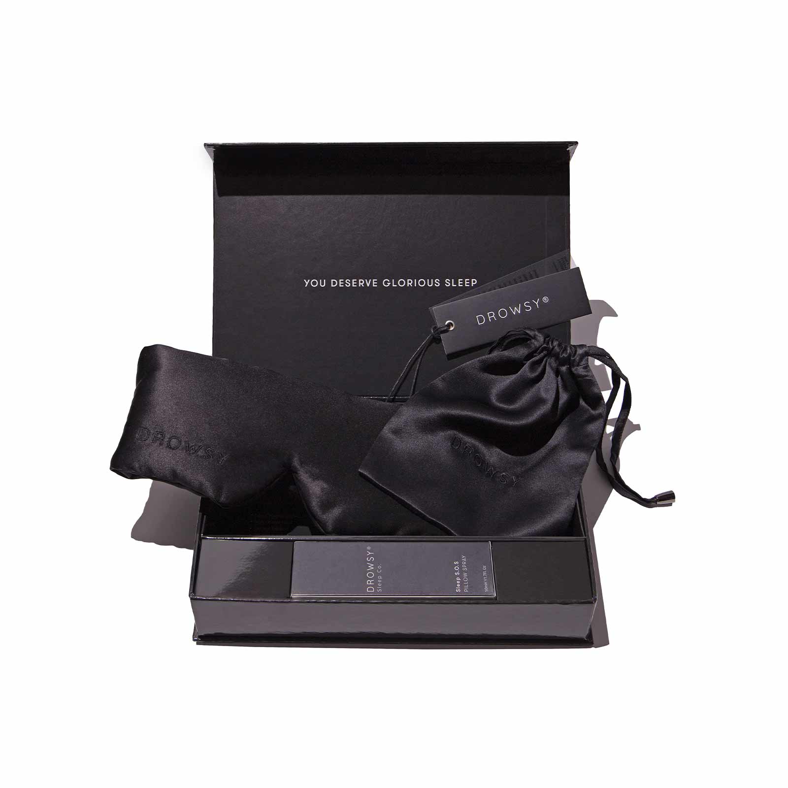 Drowsy Sleep Co Black Gift Box open with mask and pillow spray displayed inside on white background