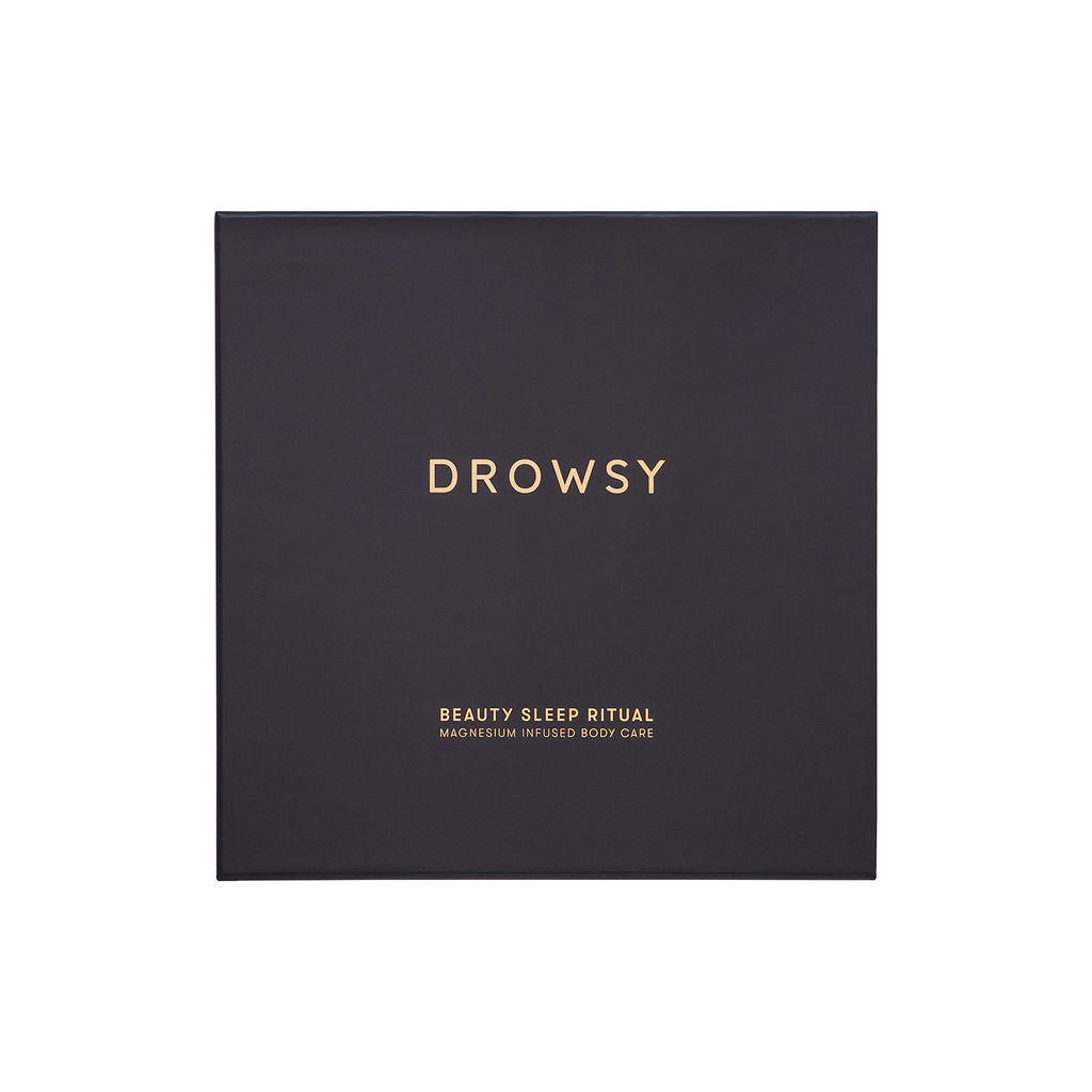 A black square box with gold text for us.drowsysleepcos Beauty Sleep Ritual is centered on a white background. This magnesium-infused duo is perfect for enhancing your beauty sleep routine.