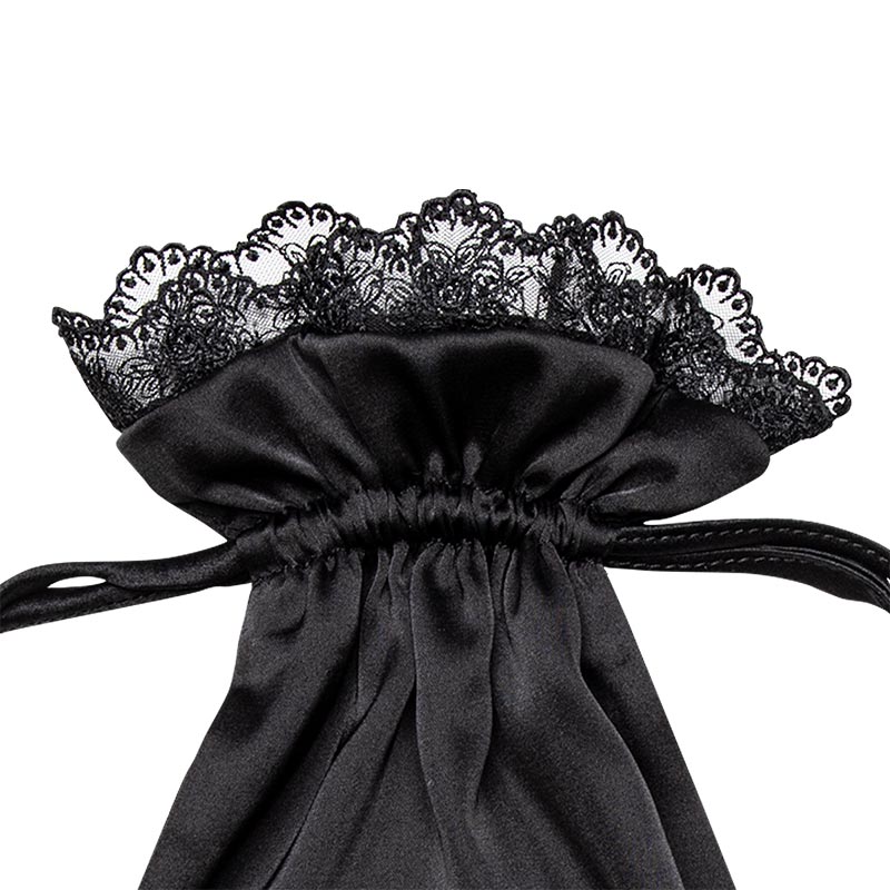 A close-up of the drowsysleepco Paris Love Story Silk Carry Pouch in black satin, featuring a gathered and tied design with elegant black lace trim at the top.
