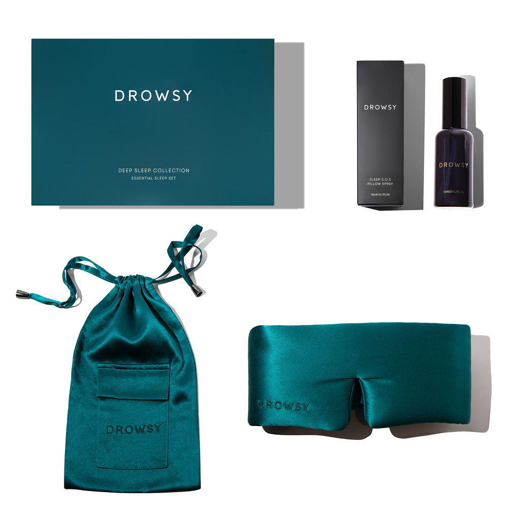 The Green Sapphire - Deep Sleep Collection by us.drowsysleepco features a luxury teal silk sleep mask, matching pouch, deep sleep pillow spray in a box, and a branded gift box—all displayed on a white background.