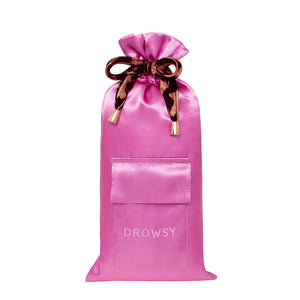 The Hotel Paradiso Carry Pouch from us.drowsysleepco is a bright pink satin bag with a front pocket, "DROWSY" embroidery, and a patterned ribbon—perfect for keeping your silk eye mask and essentials organized in style.