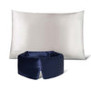 The Perfect Skin Bundle Midnight Blue by drowsysleepco features a white silk pillowcase and a navy blue padded sleep mask, displayed on a white background with the mask in front of the pillow for the ultimate beauty sleep.