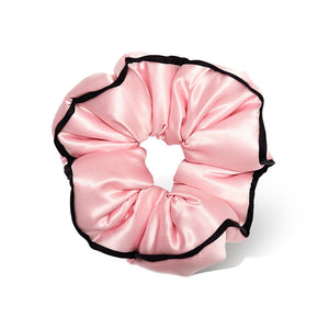 The drowsysleepco Sleep and the City - Pink Padded Scrunchie features shiny pink satin with black trim, shown against a white background.