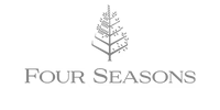 The image shows the Four Seasons Hotels and Resorts logo, featuring a stylized tree above the words FOUR SEASONS in uppercase letters. The text and the tree are in a simple, elegant gray font.