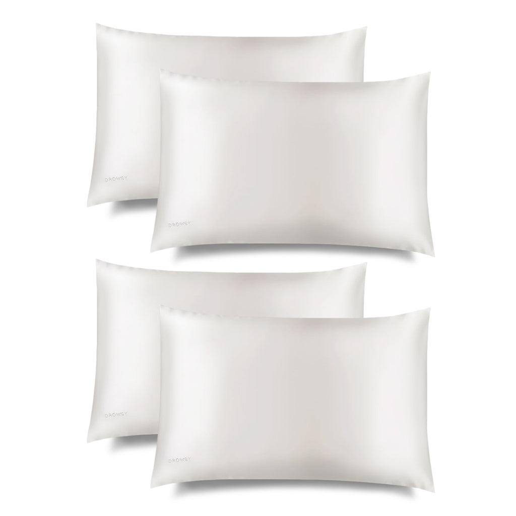 Four white Akoya Pearl Silk Pillowcases (King Size) by us.drowsysleepco are arranged in two rows on a plain white background, each slightly overlapping—a nightly hair-protecting and skincare essential.