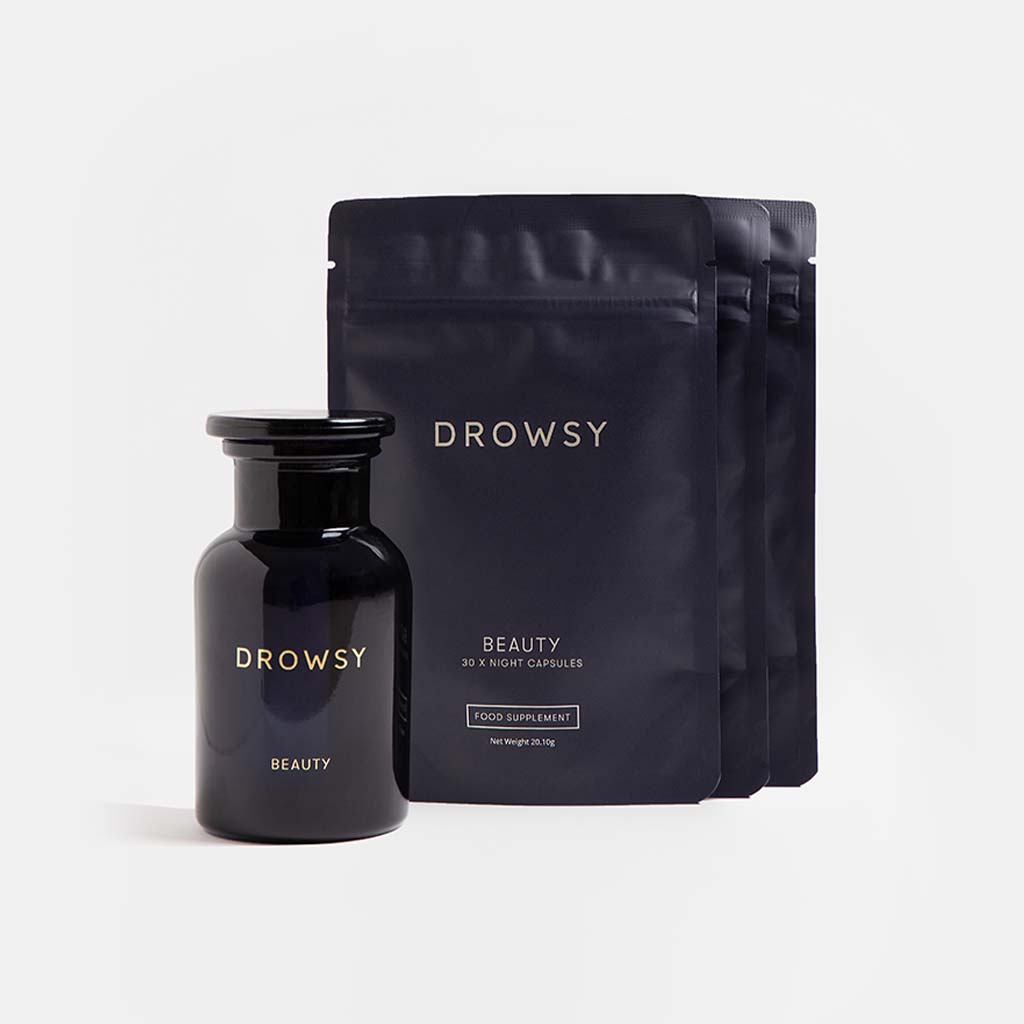 A dark glass bottle and three black resealable pouches labeled drowsysleepco Supplements - Beauty are displayed on a white background. These skin supplements may help support collagen synthesis for youthful-looking skin.