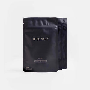 Three black resealable pouches of drowsysleepcos Sleep Supplement Subscription, each labeled with 30 capsules, are arranged in a staggered row on a plain white background.