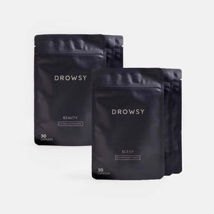 Two dark resealable pouches from drowsysleepco’s Beauty Sleep Clinic Subscription—one labeled Beauty, the other Sleep, each with 30 capsules—are neatly arranged on a light gray background.