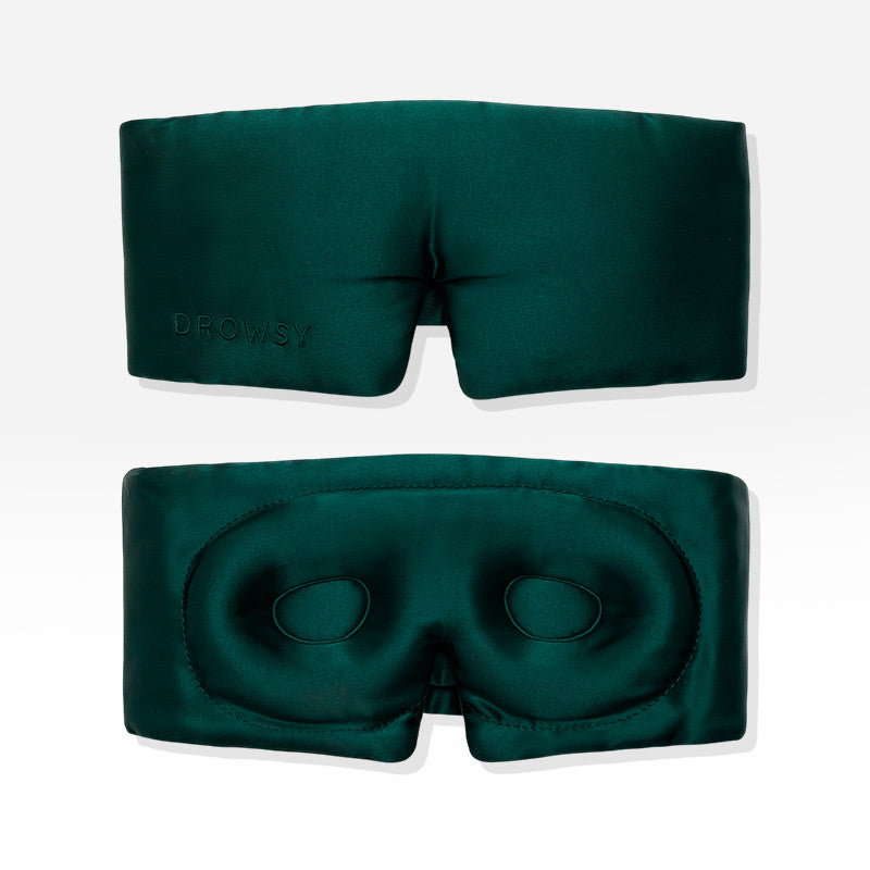 Two Ivy Green - Eyelash Protecting Masks by us.drowsysleepco are shown against a white background. One mask displays the exterior, featuring “DROWSY” embroidery, while the other reveals the interior with contoured eyecups and a nose cutout designed for eyelash protection.