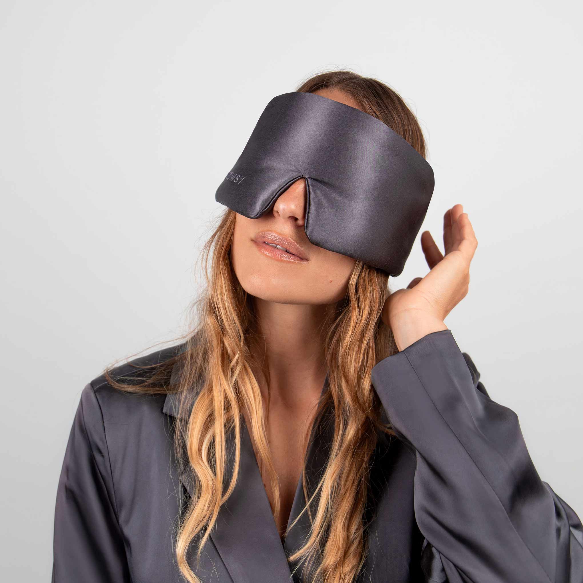 Model with grey Drowsy silk sleep mask covering her eyes