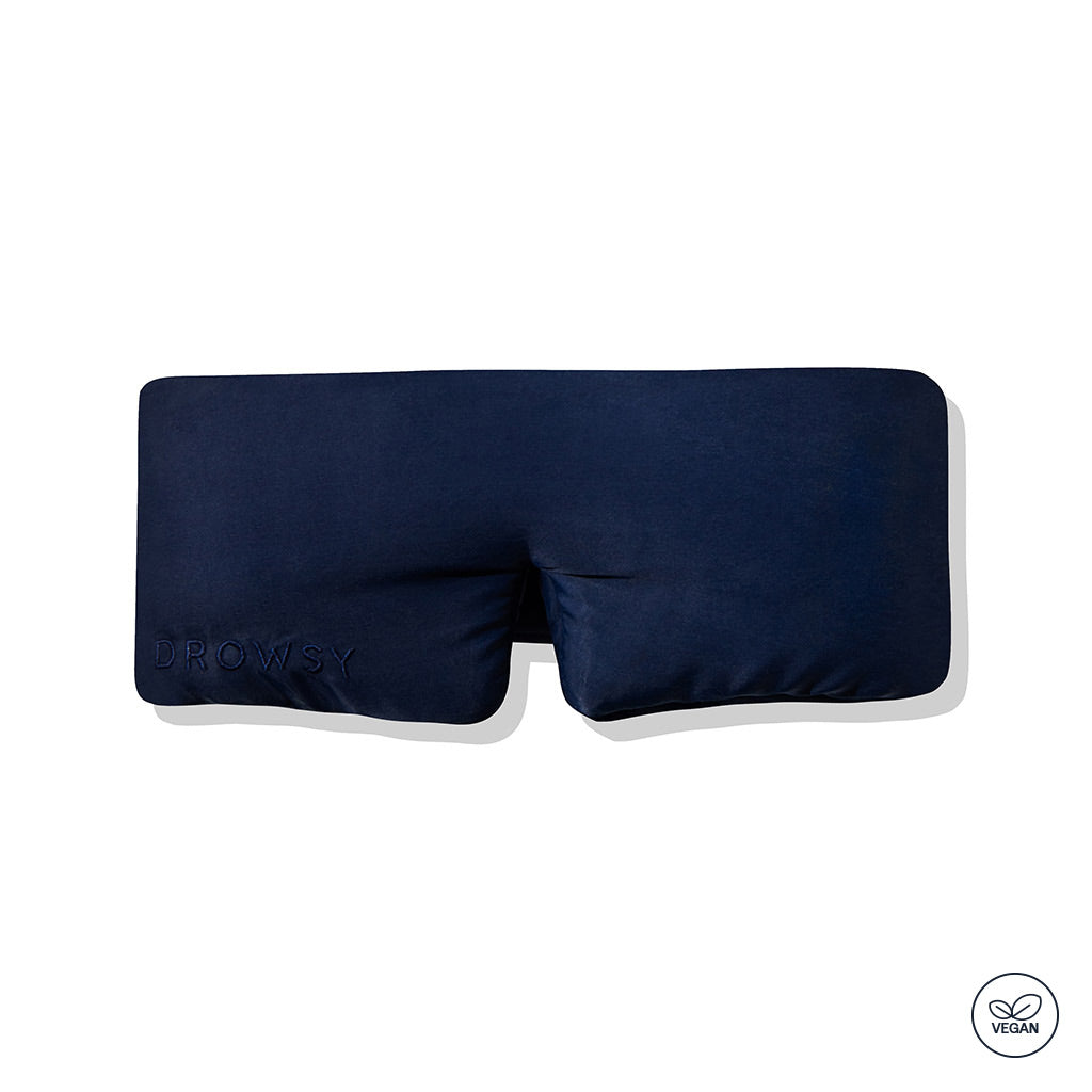 The Midnight Blue - Vegan Silk Sleep Mask by drowsysleepco is a dark blue rectangular mask with 