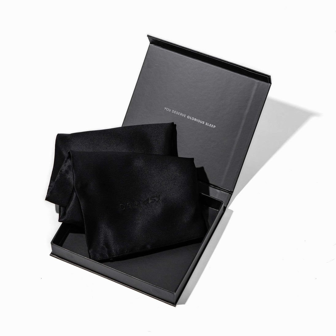 Black pillowcase box opening with black silk pillowcase inside