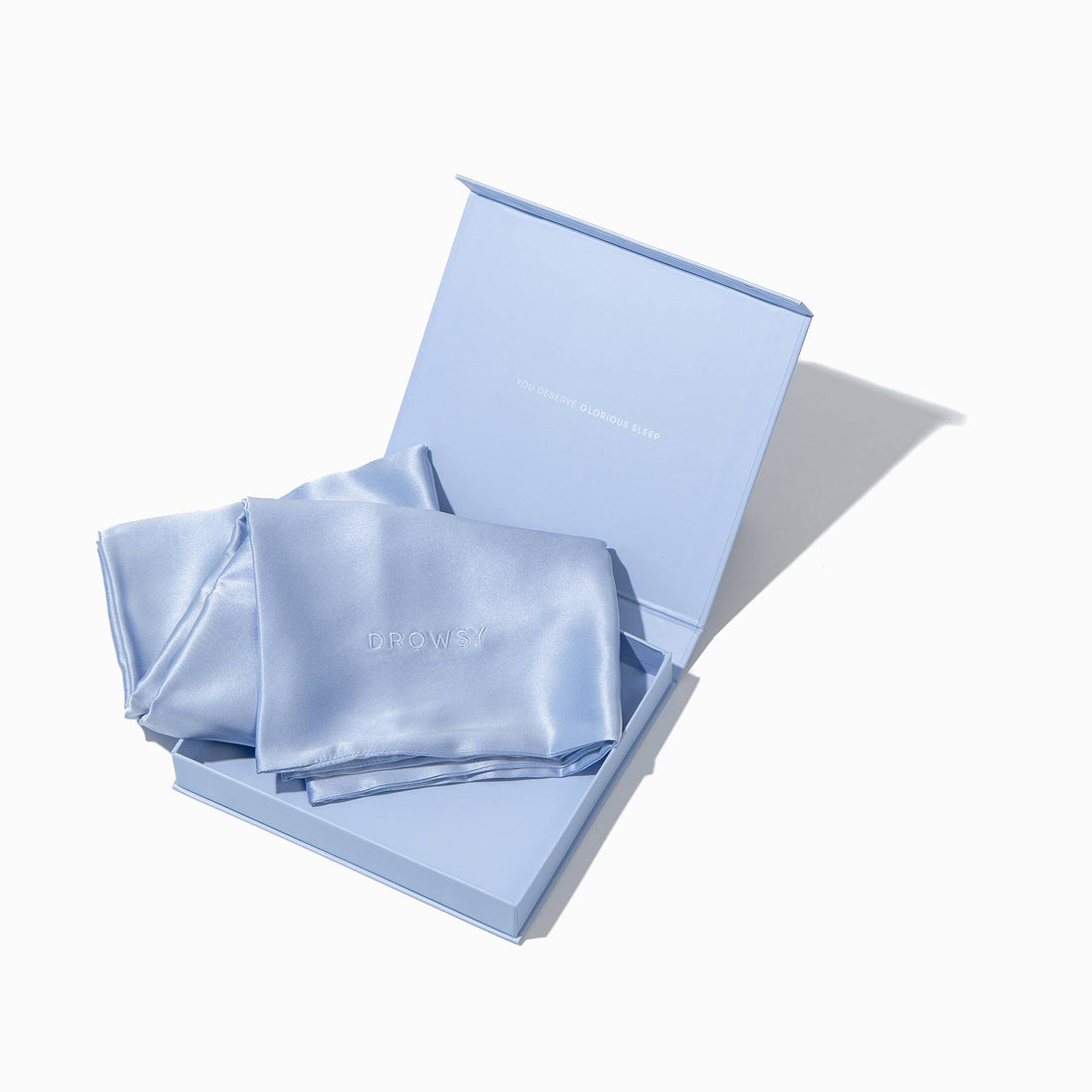 Blue pillowcase box opening with blue silk pillowcase inside