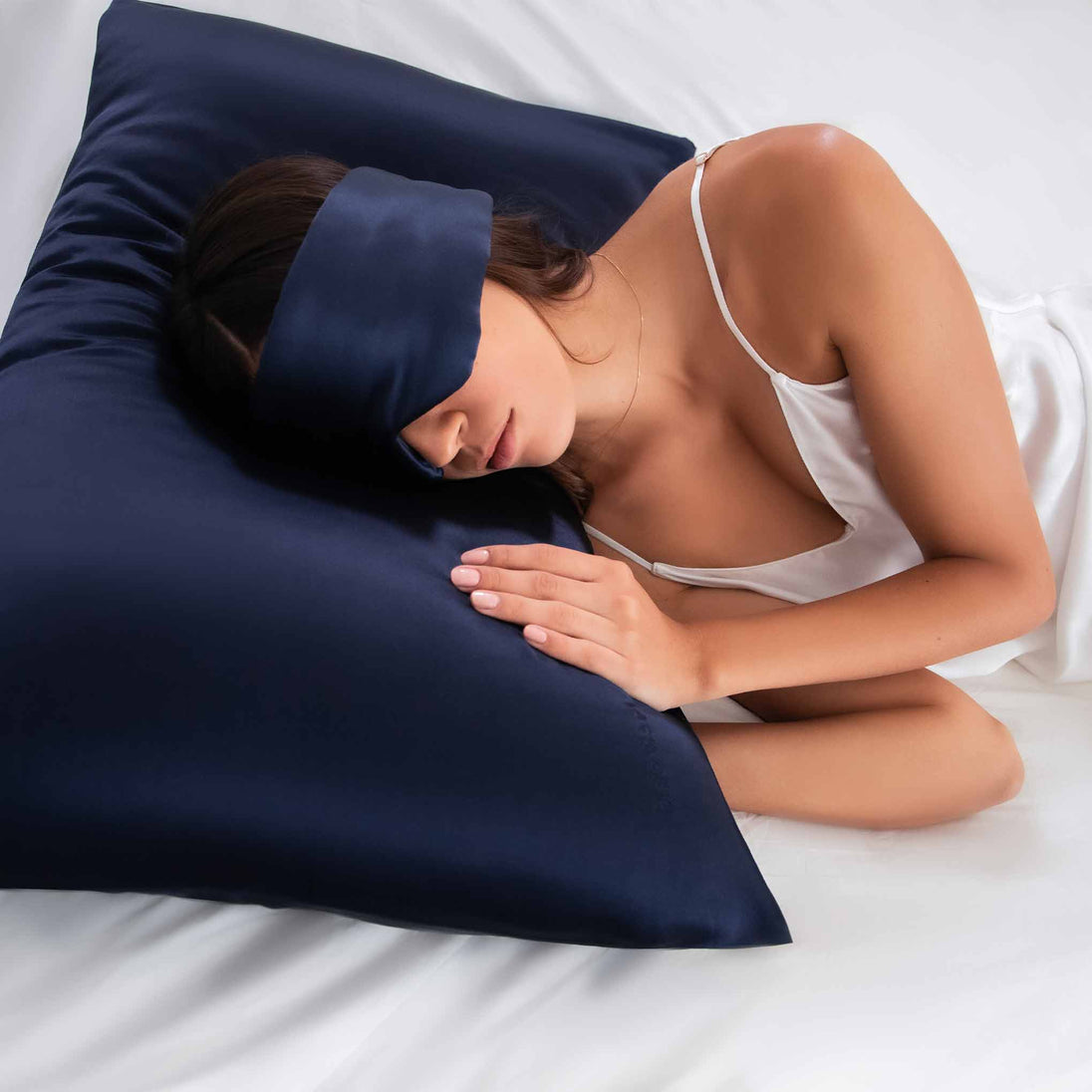 Girl sleeping on blue pillowcase with Drowsy Sleep Co. Sleep mask over eyes