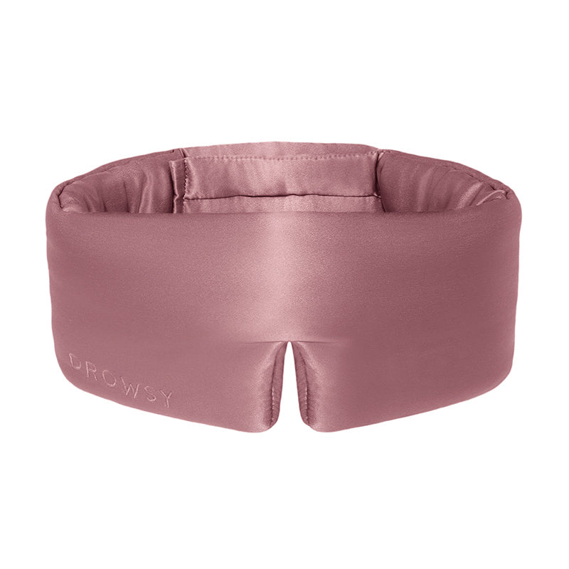 The Damask Rose eye mask by drowsysleepco is wide, silky pink with Drowsy embossed on the front, a central notch, and a soft padded blackout interior for enhanced comfort and rest.
