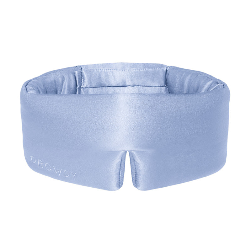 Introducing the Blue Belle eye mask by us.drowsysleepco—a light blue, padded silk mask with a unique wraparound design and a notch at the bottom center. The word 
