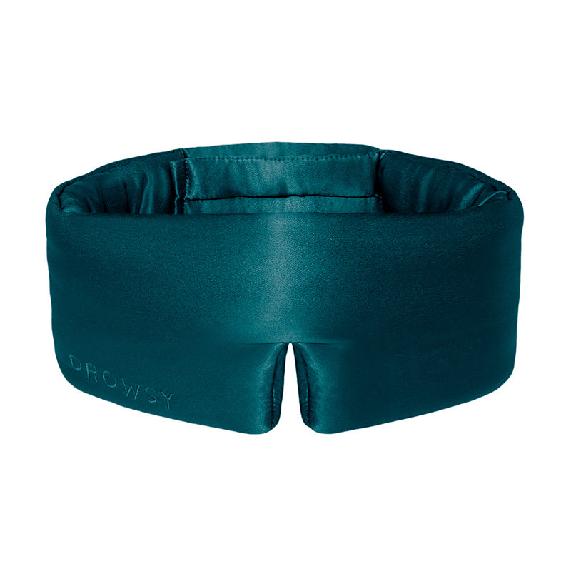 Green Sapphire by us.drowsysleepco is a luxurious teal silk eye mask embroidered with DROWSY, ideal for beauty sleep and improved skin hydration.