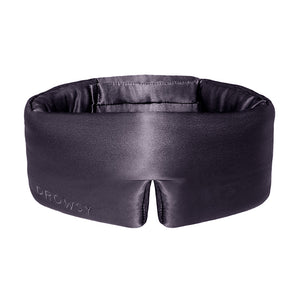 Experience ultimate beauty sleep with the Moonlight Shadow by us.drowsysleepco—a padded black silk eye mask featuring a wide band and a stylish front split, elegantly embroidered with "DROWSY" on the left side.