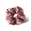 The Damask Rose - Padded Scrunchie by us.drowsysleepco is a shiny, light pink oversized silk scrunchie displayed in a circular shape on a white background with a soft shadow to the right.