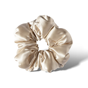 The Dusty Gold - Padded Scrunchie by us.drowsysleepco features a smooth, shiny finish in a circular shape—a chic and oversized hair accessory ideal for stylish sleep.