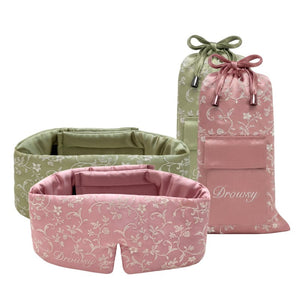 Two Pride & Prejudice - Complete collection original floral-patterned mulberry silk sleep masks in pink and sage green, each paired with a matching drawstring storage pouch.